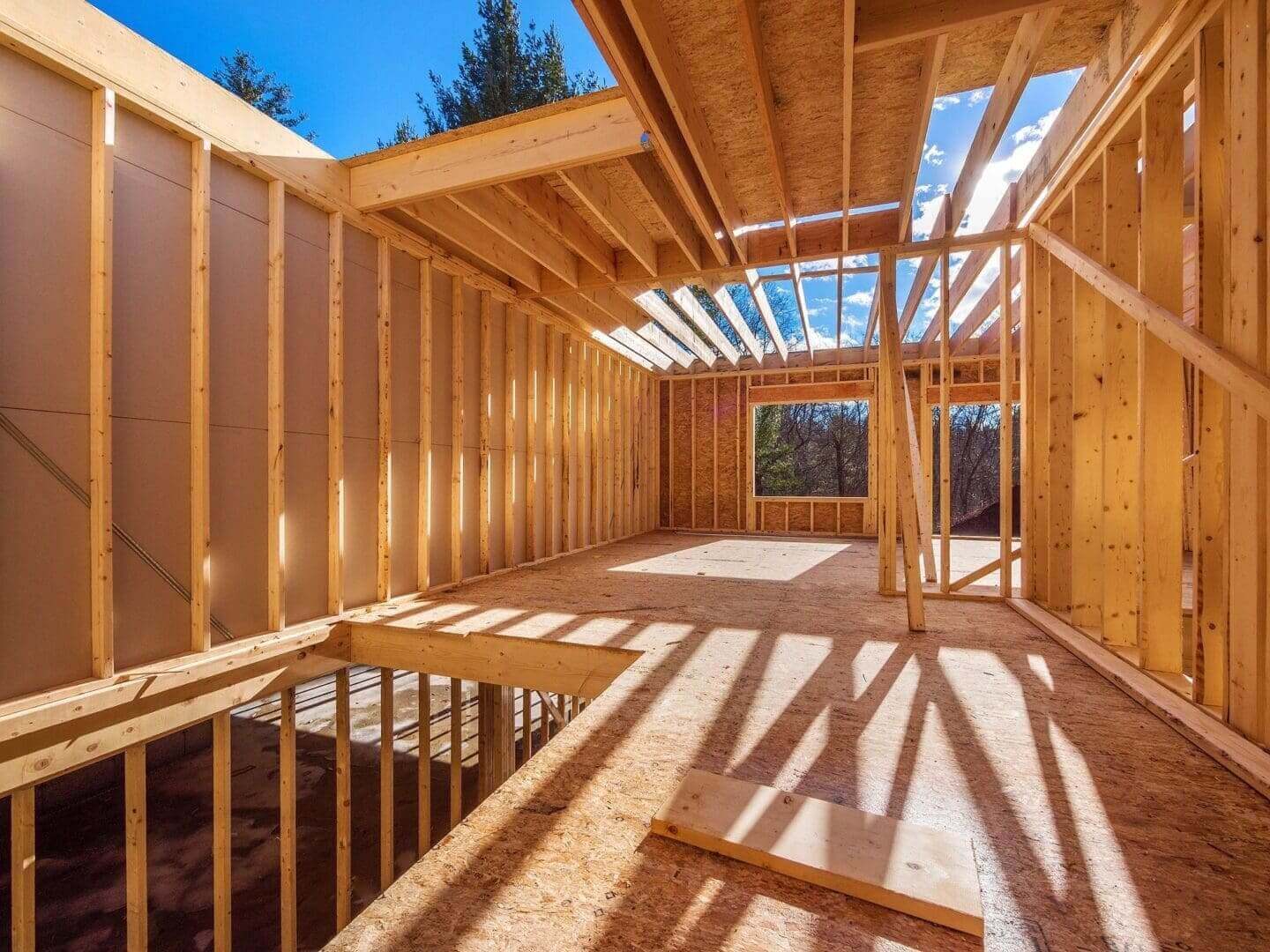 Wooden frame house under construction.